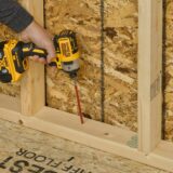 A professional is installing FastenMaster’s FrameFAST framing screw.